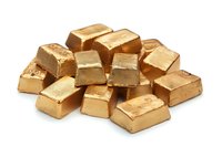Stack of shiny gold bars isolated on white background, showing wealth, investment and financial concept. Precious metal bullion arrangement.