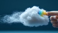 Fingers holding fluffy white cloud with rainbow colors dispersing into misty smoke effect against dark blue background, creative conceptual composition for cloud computing.