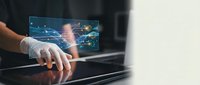 Business professional using futuristic holographic interface with digital network connections and data visualization technology for modern workplace solutions.