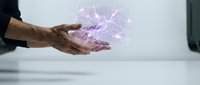 Male hands holding glowing purple energy sphere with electric lightning effects for technology, magic, power and innovation concepts.