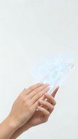 Hands holding transparent digital tablet with holographic interface display against white background for technology concepts.
