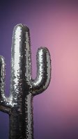 Shimmering silver sequined cactus sculpture against vibrant purple pink gradient background for party decoration and festive design concepts.