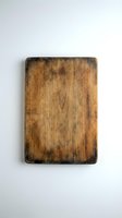 Aged wooden cutting board with dark stains and weathered surface texture, isolated on white background for kitchen design, cooking content, and rustic home decor projects.