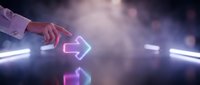 Hand pointing at glowing neon arrow sign in futuristic digital environment with light trails and bokeh effects for technology and direction concepts.