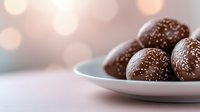 Dark chocolate truffles with coconut flakes served on white ceramic plate against soft bokeh background, elegant dessert presentation for confectionery and bakery.