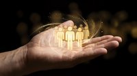 Open palm holding glowing golden human figures with magical light particles and swirling energy, symbolizing teamwork, community, leadership, and human connection for business concepts.