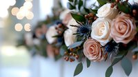 Delicate peach roses and blue thistles in elegant wedding bouquet with eucalyptus leaves and berries against soft bokeh background, romantic floral arrangement.