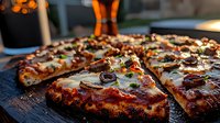 Grilled pizza slices with melted cheese, olives and herbs on wooden board. Perfect for restaurant menus, food blogs and culinary advertising materials.