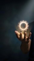Hand holding glowing gear symbol against dark background, representing innovation, technology, engineering, and business solutions for corporate and industrial design projects.