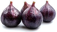 Fresh ripe purple figs with water drops on dark skin arranged in row on white background, macro food photography showing natural texture and juicy detail.