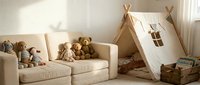 Cozy children playroom with cream sofa, teddy bears collection and wooden teepee tent creating warm family space for kids activities and imaginative play.