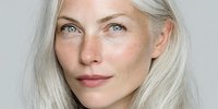 Mature Caucasian woman with platinum blonde hair and natural makeup showcasing confident expression and healthy aging skincare routine for beauty campaigns.