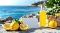 Fresh lemons and homemade limoncello liqueur on wooden table against blue sea background, with blank white card for text. Mediterranean summer drink setting.