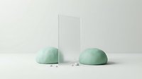 Pair of green jade stone hemispheres with clear glass rectangular prism on neutral background, isolated for design mockups and product presentations.