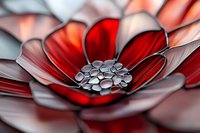 Macro shot of red and silver metallic flower with detailed center pattern, abstract floral art design with dramatic lighting and soft focus background.