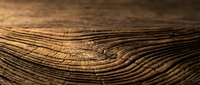 Aged wooden surface with natural grain patterns and weathered texture for rustic design projects and organic backgrounds.