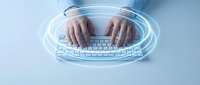 Young man with medium skin tone typing on wireless keyboard with glowing digital interface overlay, representing technology, connectivity, and modern computing for web design and software development projects.