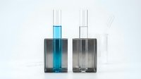 Two test tubes with blue and clear liquids in dark square holders on white background, suitable for chemistry, science education, laboratory research, and medical or pharmaceutical applications.