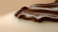 Melted dark chocolate dripping and swirling with glossy smooth texture against light brown background, creating luxurious dessert or confectionery design element.