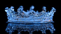 Crown shaped water splash with mirror reflection on dark background, frozen motion liquid photography in bright blue color with droplets forming royal diadem pattern.