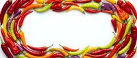 Fresh red and yellow hot chili peppers arranged in oval frame on white background, suitable for food packaging, recipe blogs, spice labels, and culinary marketing materials.