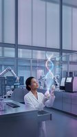 Female scientist examining holographic DNA double helix in modern laboratory with advanced equipment and digital displays for genetic research and biotechnology.