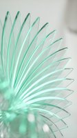 Translucent mint green spiky spherical form with radiating needle-like structures creating geometric pattern, isolated on white background for design projects, wallpapers, and digital art applications.