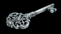 Ornate silver skeleton key with decorative floral head isolated on transparent background, ready for t-shirt design, clipart, stickers, sublimation and print-on-demand projects.