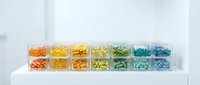 Colorful organized pill organizer with rainbow gradient medication compartments for weekly health management and pharmaceutical storage.