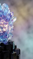 Iridescent crystal cluster with rainbow reflections on dark geometric base against soft blurred background for spiritual wellness and meditation concepts.