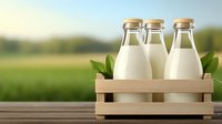 Fresh milk bottles in wooden crate with green leaves on rustic table against blurred natural background, dairy farm concept for organic products.