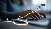 Business person typing on laptop with glowing path and location markers, digital journey concept with figure carrying flag representing achievement and goal setting.