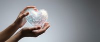 Hands protecting glowing geometric heart symbol representing healthcare technology, medical innovation, cardiology care, wellness protection and digital health solutions.