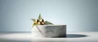 Modern marble podium with tropical fern leaves for luxury product display and branding presentations on clean minimalist background.