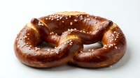 Freshly baked pretzel with golden-brown crust and coarse salt crystals, isolated on white background for food and bakery design projects.