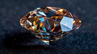 Sparkling brown diamond with brilliant facets on dark background showcases luxury gemstone with dramatic lighting and reflective surfaces.