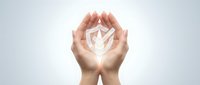 Hands holding glowing shield symbol representing protection, security, and trust for business, technology, and safety concepts.