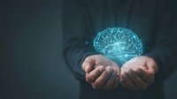 Businessman holding glowing digital brain hologram in cupped hands representing artificial intelligence, innovation and mental health concepts.