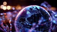 Glowing digital globe with world map illuminated against blurred bokeh background, representing global technology and international connectivity.