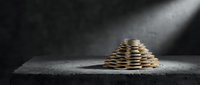 Pyramid stack of gold coins on concrete surface under dramatic spotlight, symbolizing wealth growth, savings, and financial success.