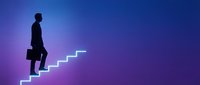 Silhouette of a male professional in business attire climbing an illuminated ascending staircase against a gradient purple and blue background, symbolizing career growth and success.