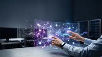 Business professional interacting with futuristic holographic interface displaying network connections and data visualization in modern office environment.