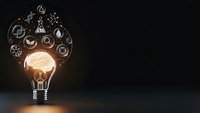 Glowing light bulb with scientific icons floating above on dark background representing innovation, research, discovery and creative thinking in science.