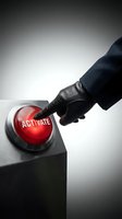 Businessman in black leather glove pressing illuminated red activate button on control panel. Concept for business initiation, system activation, and decision-making processes.