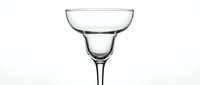 Empty margarita glass isolated on white background, elegant transparent stemware for cocktail menus, bar designs, and beverage branding projects.