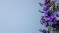 Purple anemone and lavender flowers arranged on light blue background with copy space, creating soft romantic floral composition for spring design.