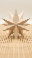 Wooden eight-pointed star decoration on bamboo mat surface with soft natural lighting for craft projects and home decor applications.