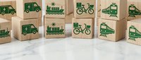Wooden blocks with green transportation icons including trucks, ships, bicycles, trains and buses representing eco-friendly logistics and sustainable delivery methods.