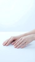 Female hands with natural manicure on white background. Clean minimal aesthetic for skincare, beauty treatments, nail care and wellness concepts.