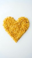 Golden heart shape made from granulated turmeric powder isolated on white background, suitable for wellness, natural remedies, and love-themed design projects.